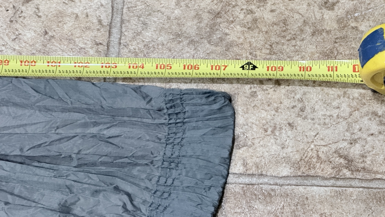 Close-up of the Nano-7 end hem beside the inch markings on the length tape.