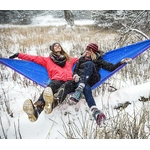 Eno DoubleNest Hammock – versatile for all seasons, shown in snowy outdoor setting with two people relaxing