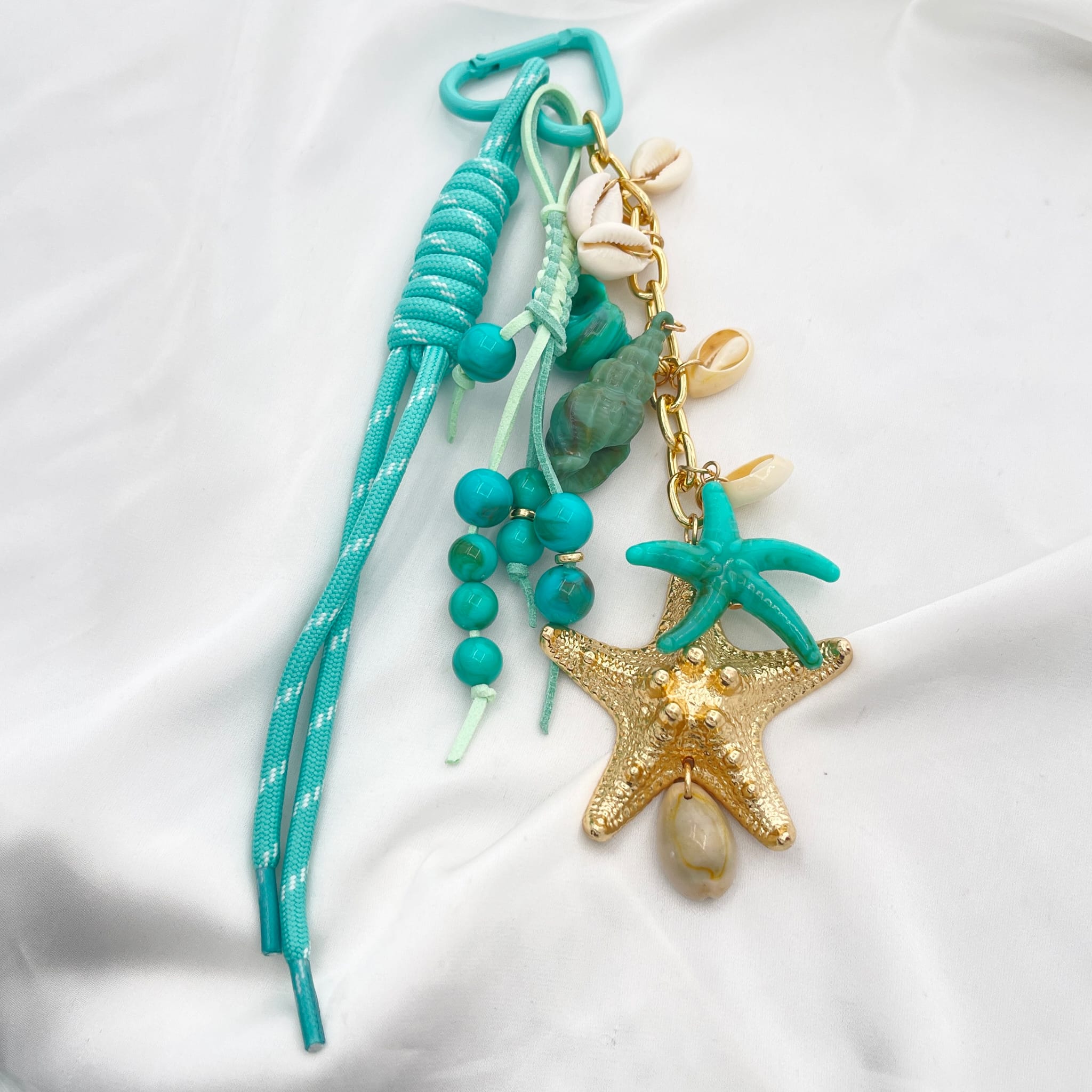 Porte clef grigri de sac étoile turquoise et doré