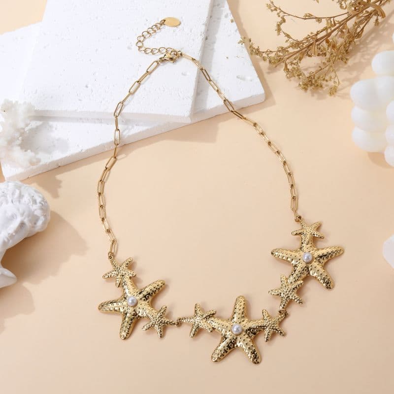 Collier gri-gri chic pampilles étoiles dorées