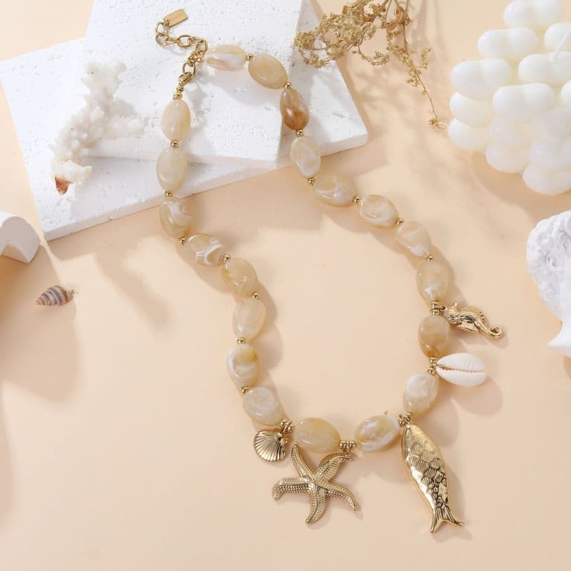 Bijou collier de créateur breloques et coquillage beige
