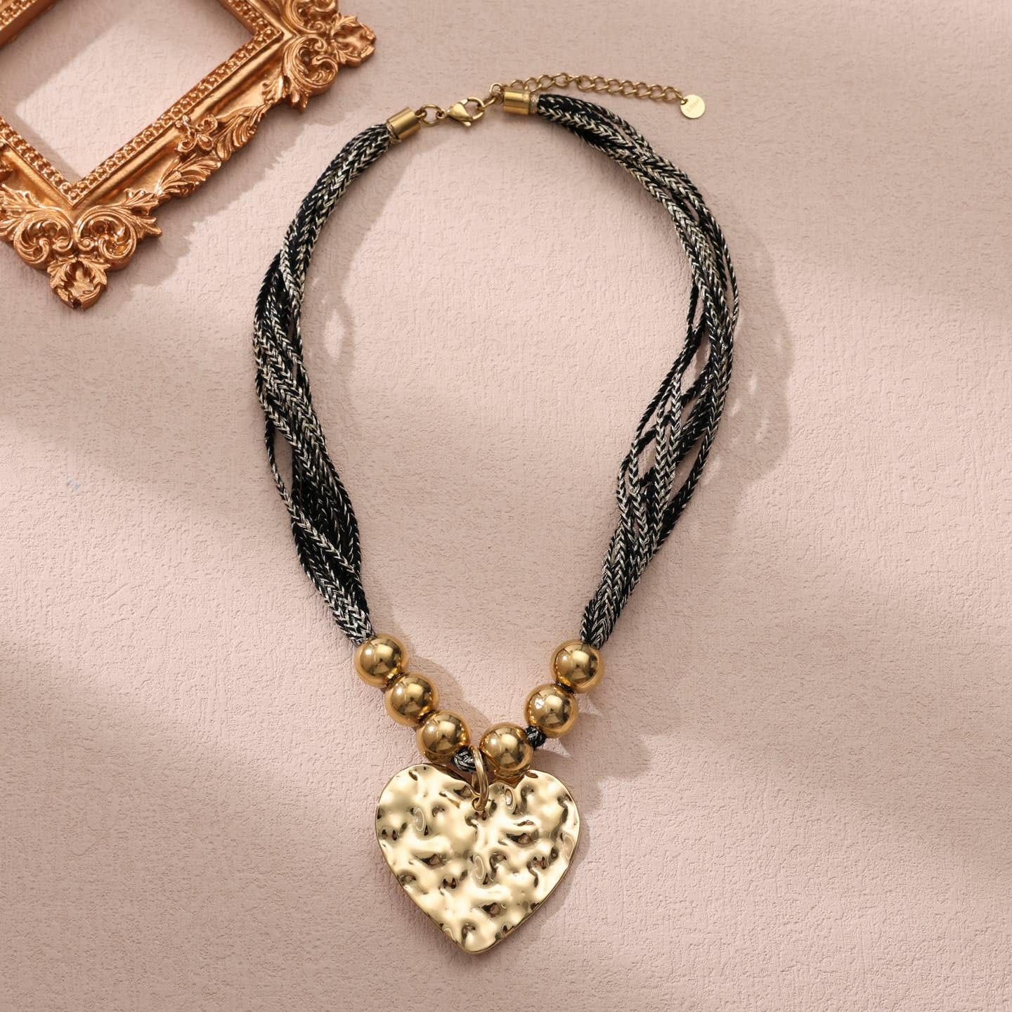 Collier multi cordons noir avec un pendentif de cœur martelé