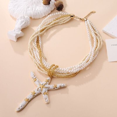 Collier breloques étoiles de mer blanche et dorée