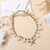 Collier gri-gri chic pampilles étoiles dorées et coquillages