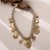 Collier beige & breloques dorées coeur femme
