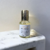 flacon de 50 ml d'eau de parfum de la marque chic olfaction portant le nom de comme un aimant posé sur une console en marbre