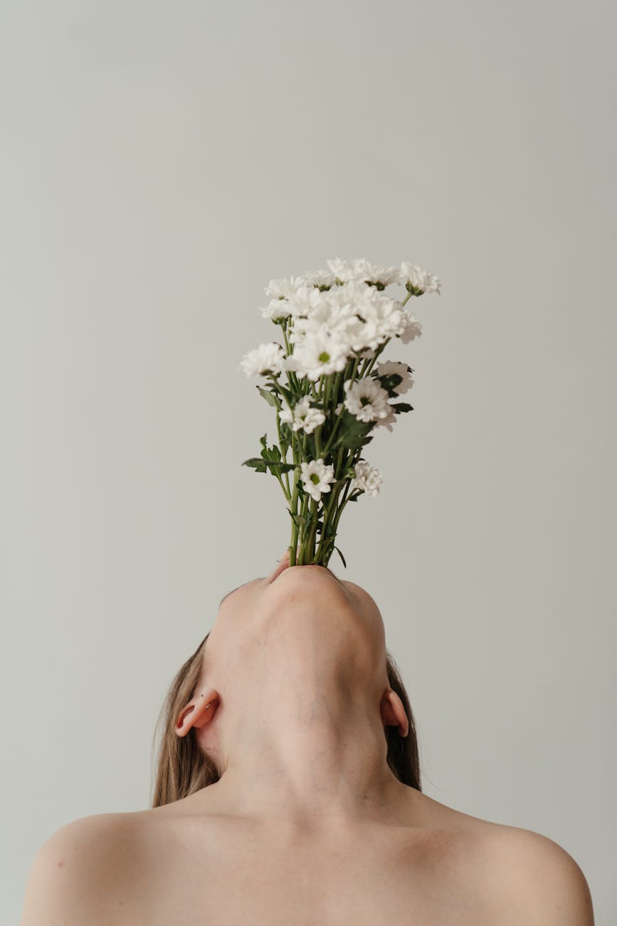 femme tenant un bouquet de fleurs blanches