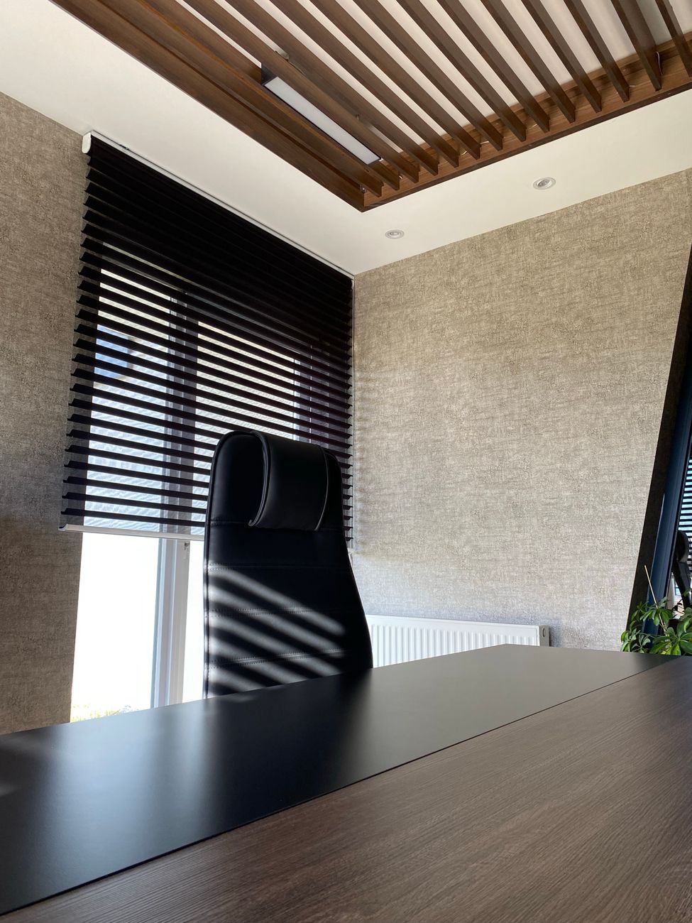 Espace de travail à domicile avec bureau épuré et stores