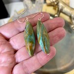 Détail des boucles d’oreilles en agate mousse aux nuances vertes
