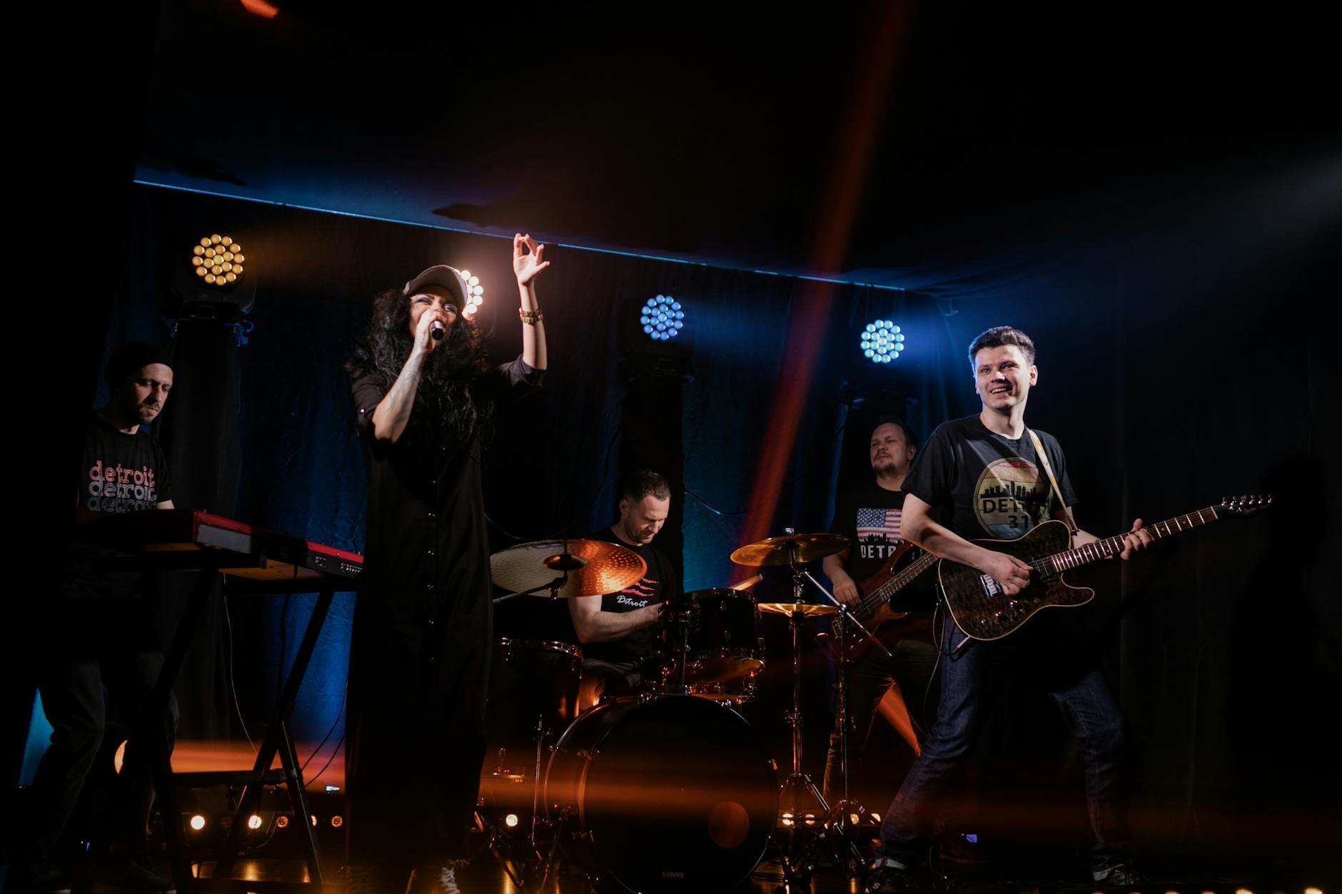 dynamic live music performance featuring a rock band with singer and instruments on stage