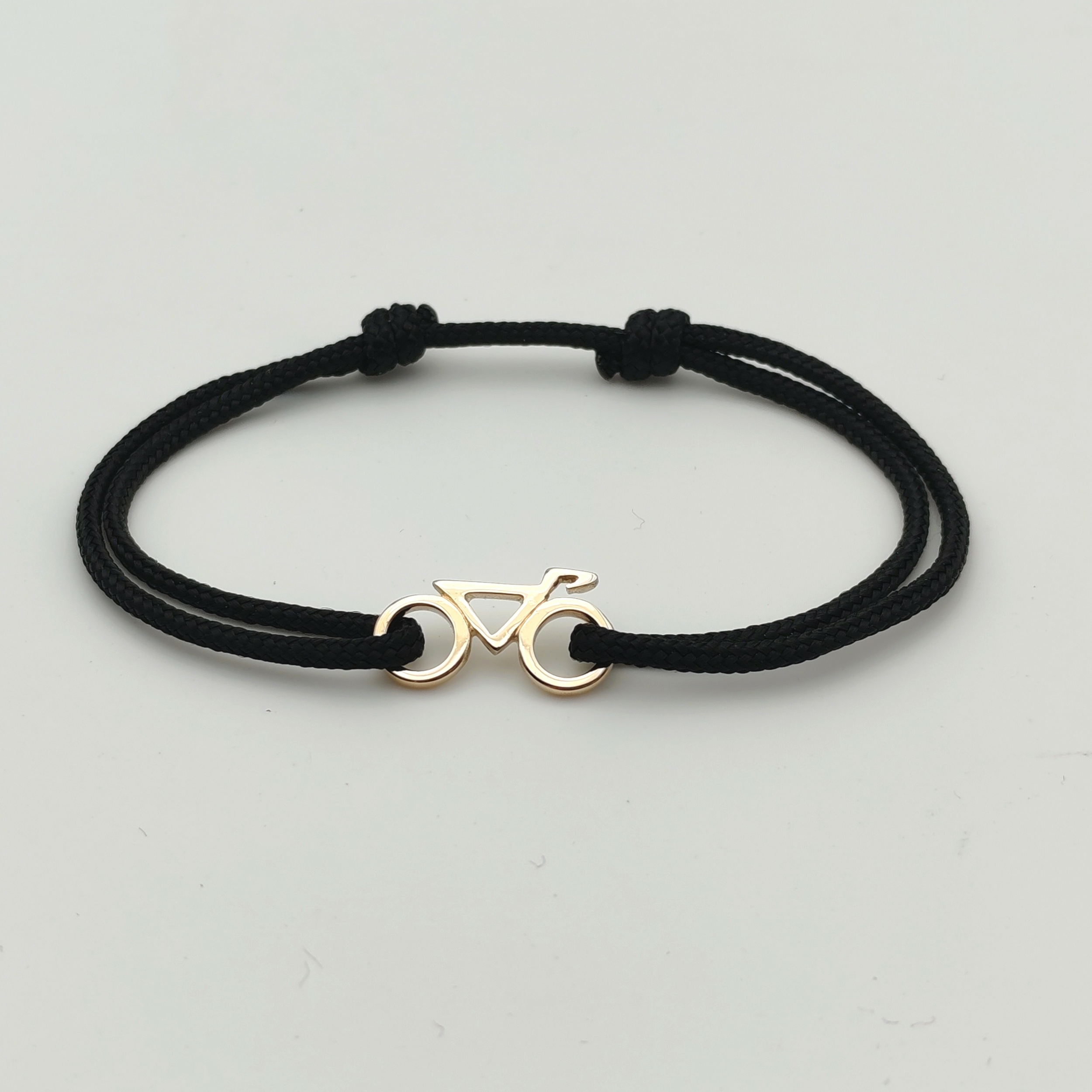 Bracelet vélo or 750 sur cordon noir
