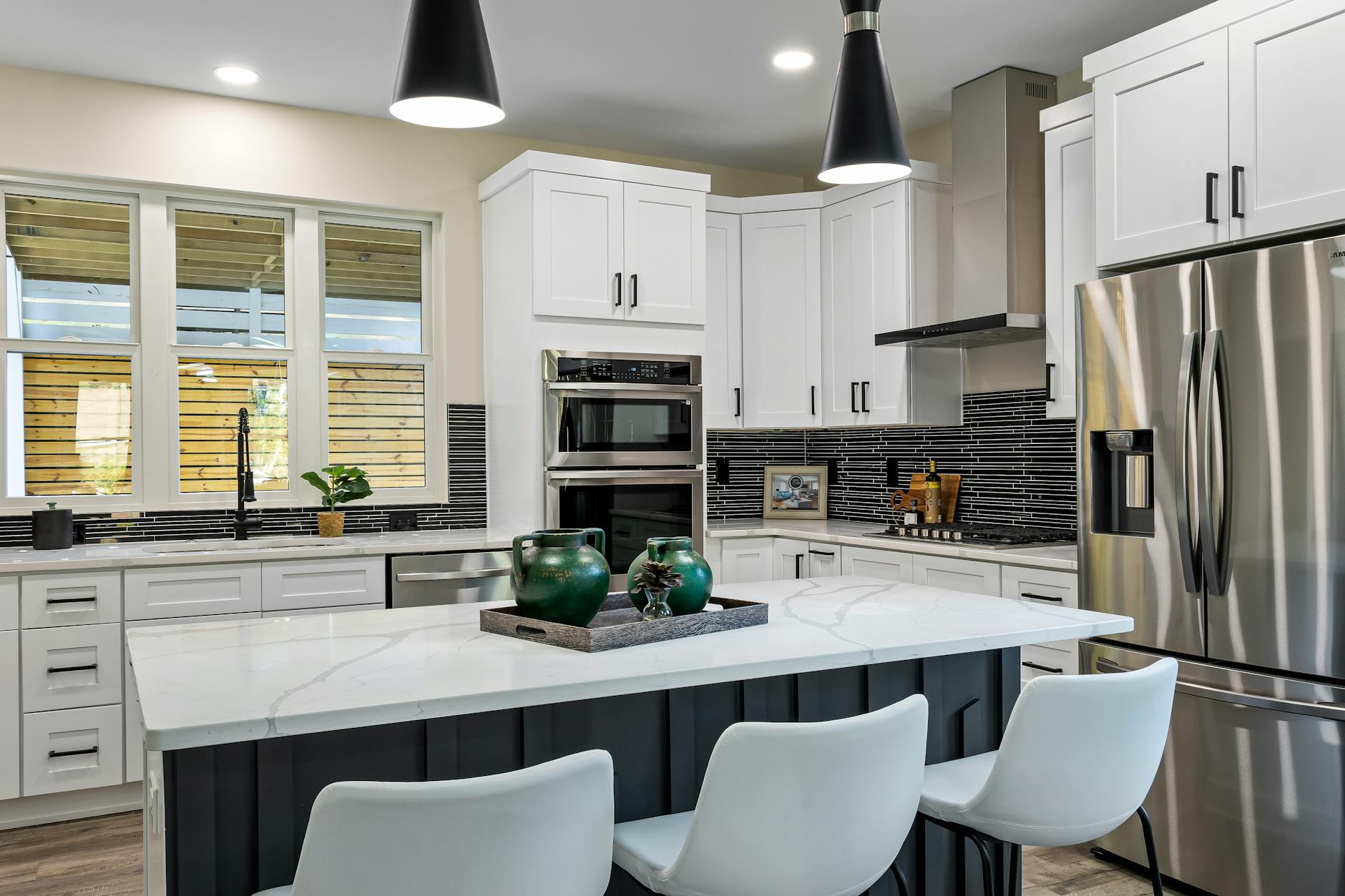 sleek modern kitchen with a marble island stainless steel appliances and stylish decor