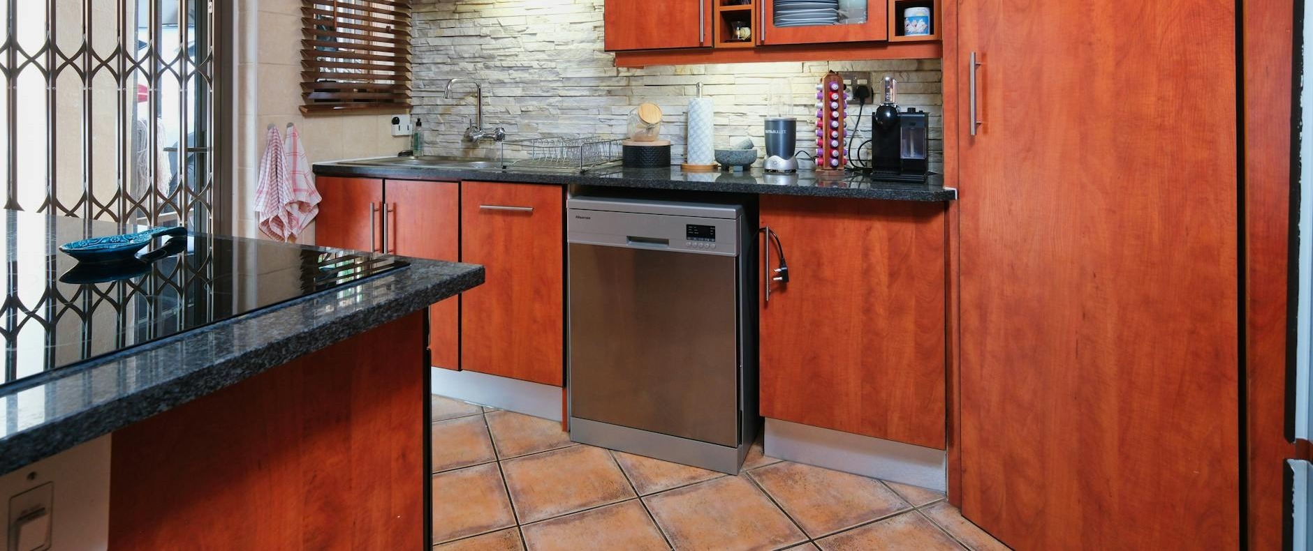 a well designed modern kitchen with redwood cabinets and sleek appliances