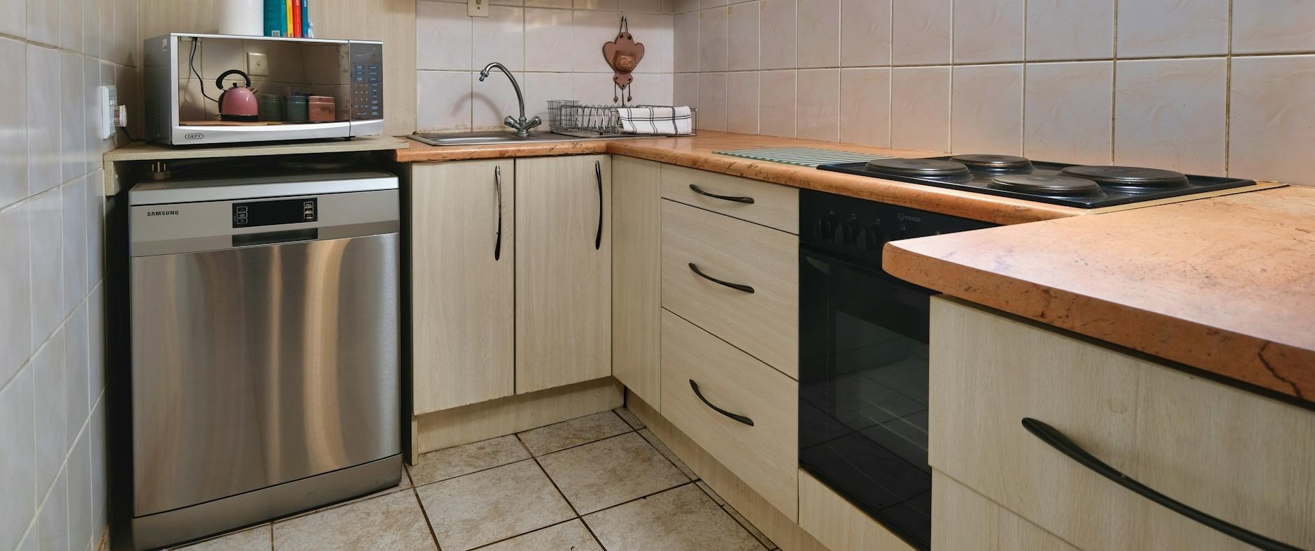 contemporary kitchen in pretoria featuring built in appliances wooden cabinets and natural lighting
