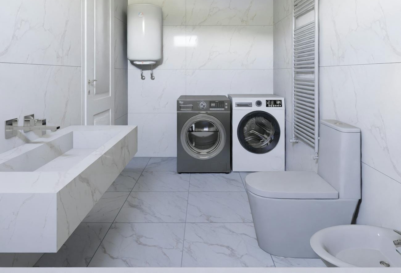 sleek bathroom with washing machine and dryer showcasing minimalist marble design