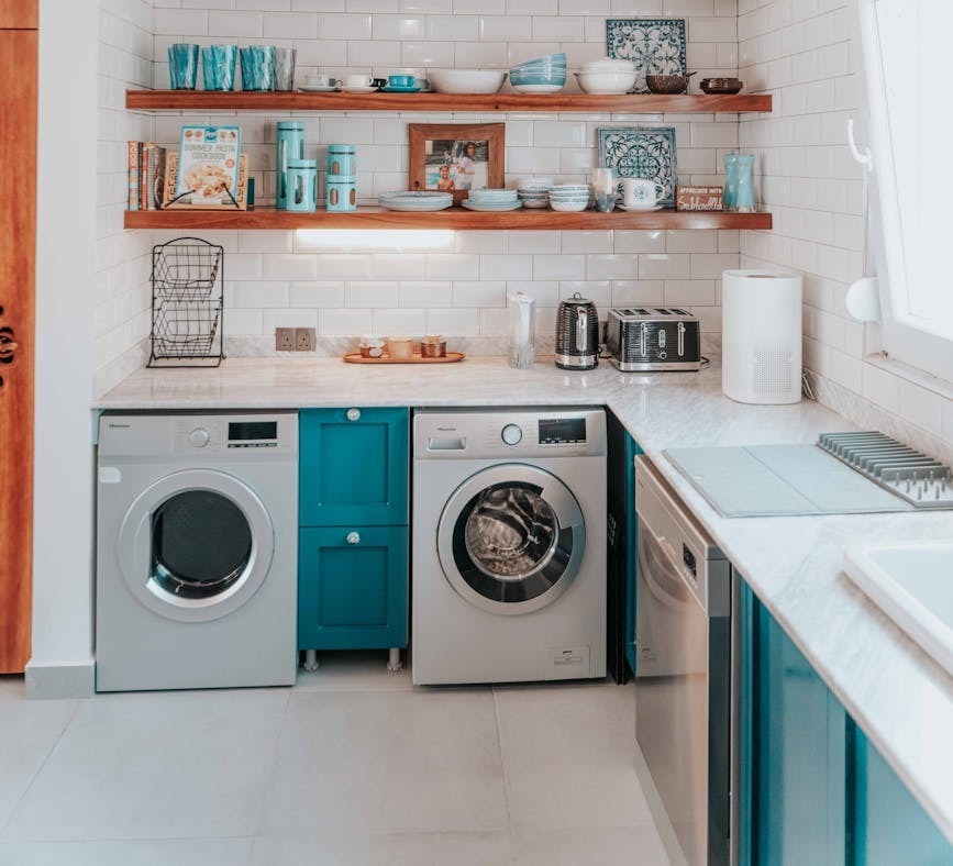 a bright modern kitchen featuring open shelving and integrated washing appliances