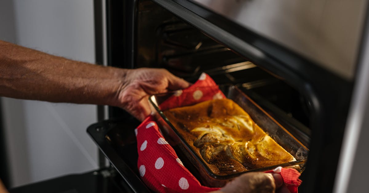 person removes freshly baked cake from oven showcasing home baking joy