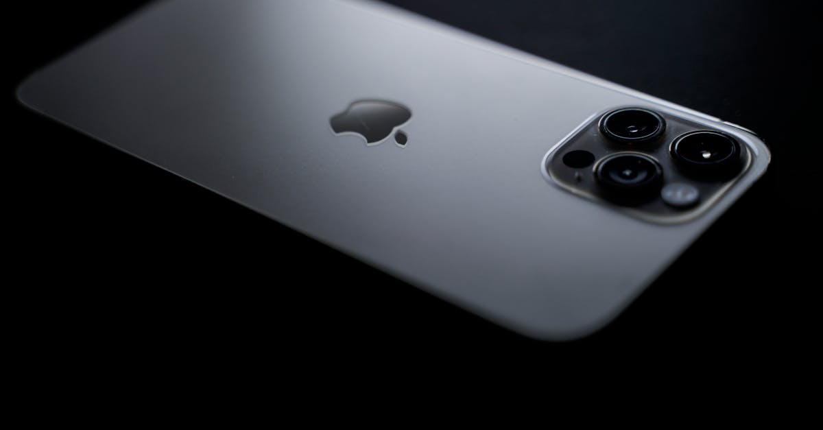 close up shot of a sleek smartphone showcasing triple camera lenses on a dark background