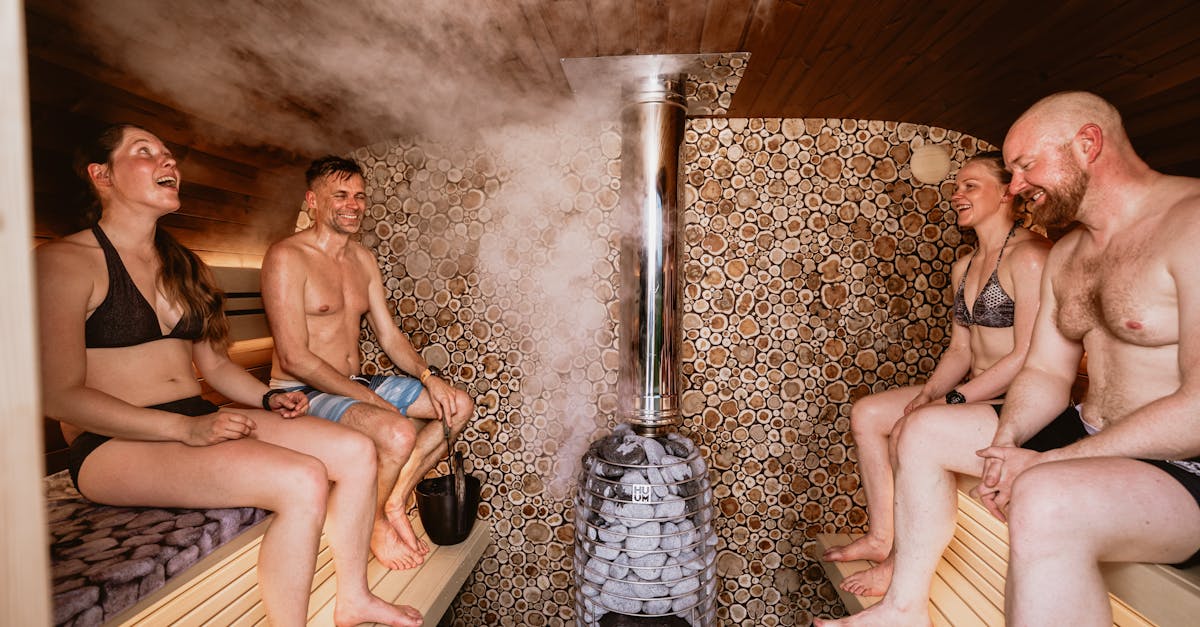 group enjoying a traditional nordic sauna session with steam and natural wood design