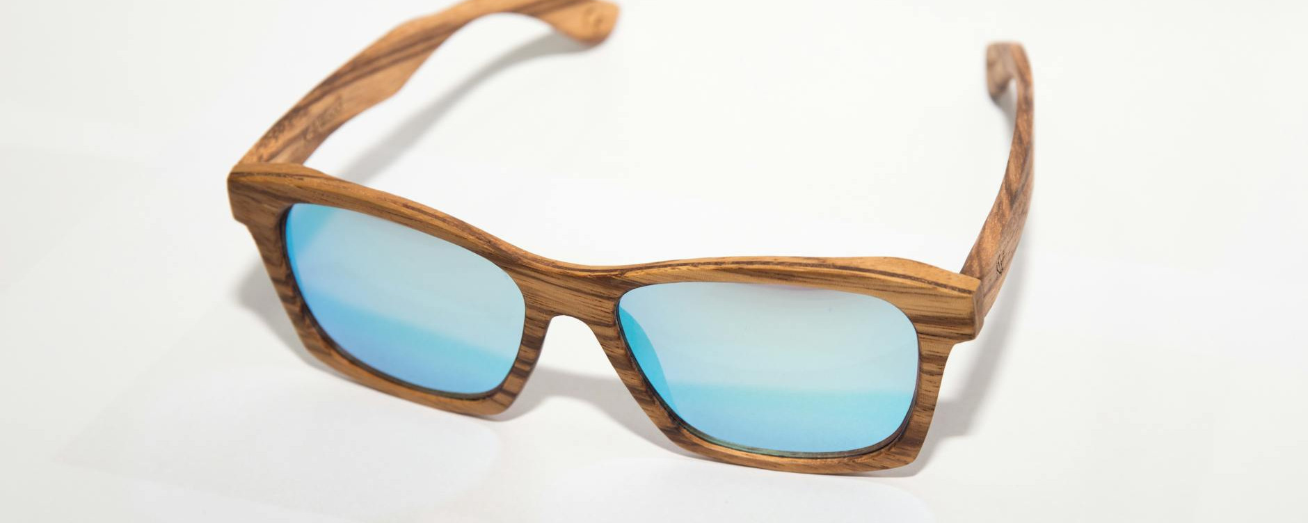 high quality sunglasses with wooden frame and blue lenses perfect for a trendy look