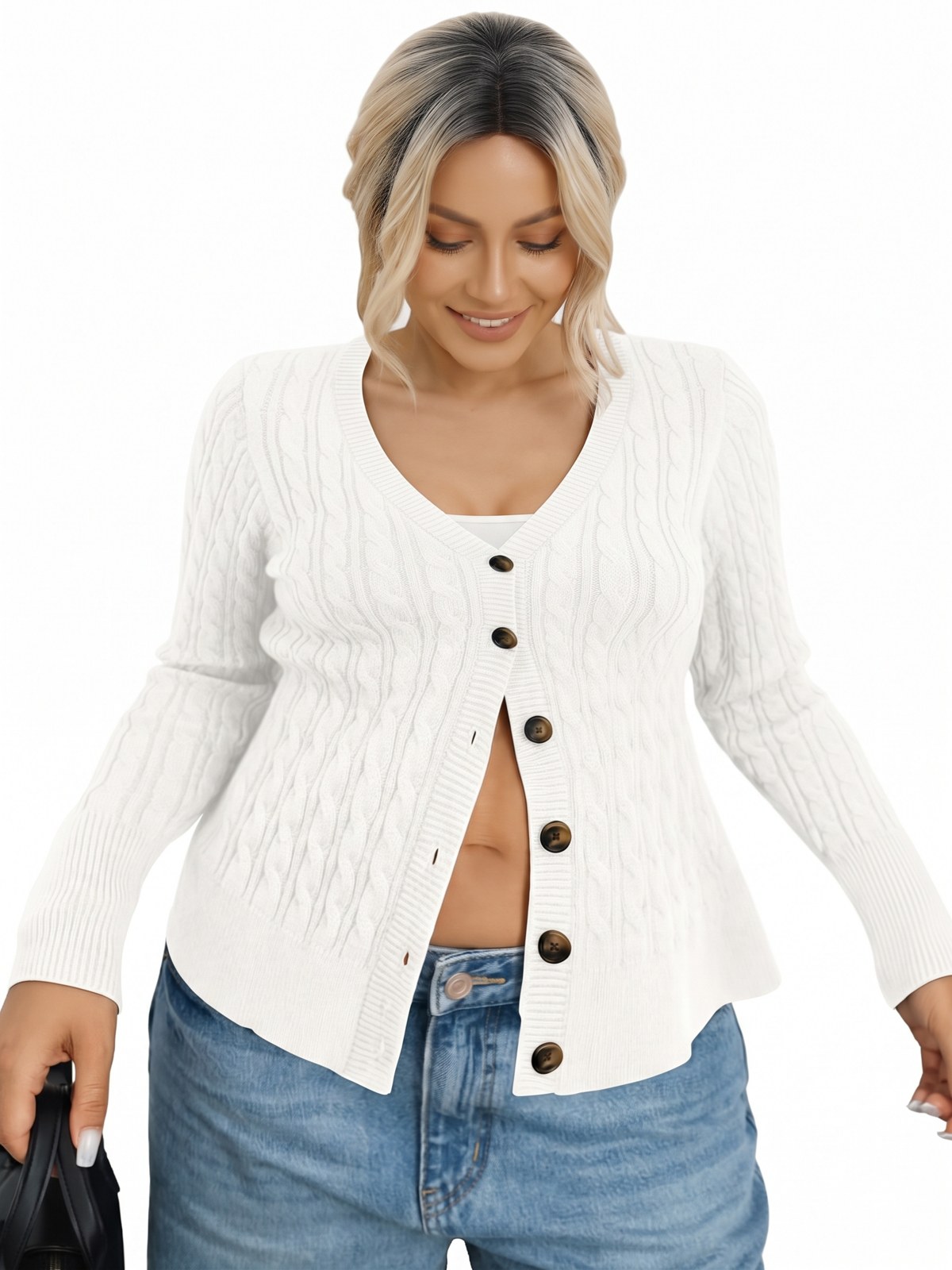 Woman wearing a white cable-knit button-down cardigan with jeans