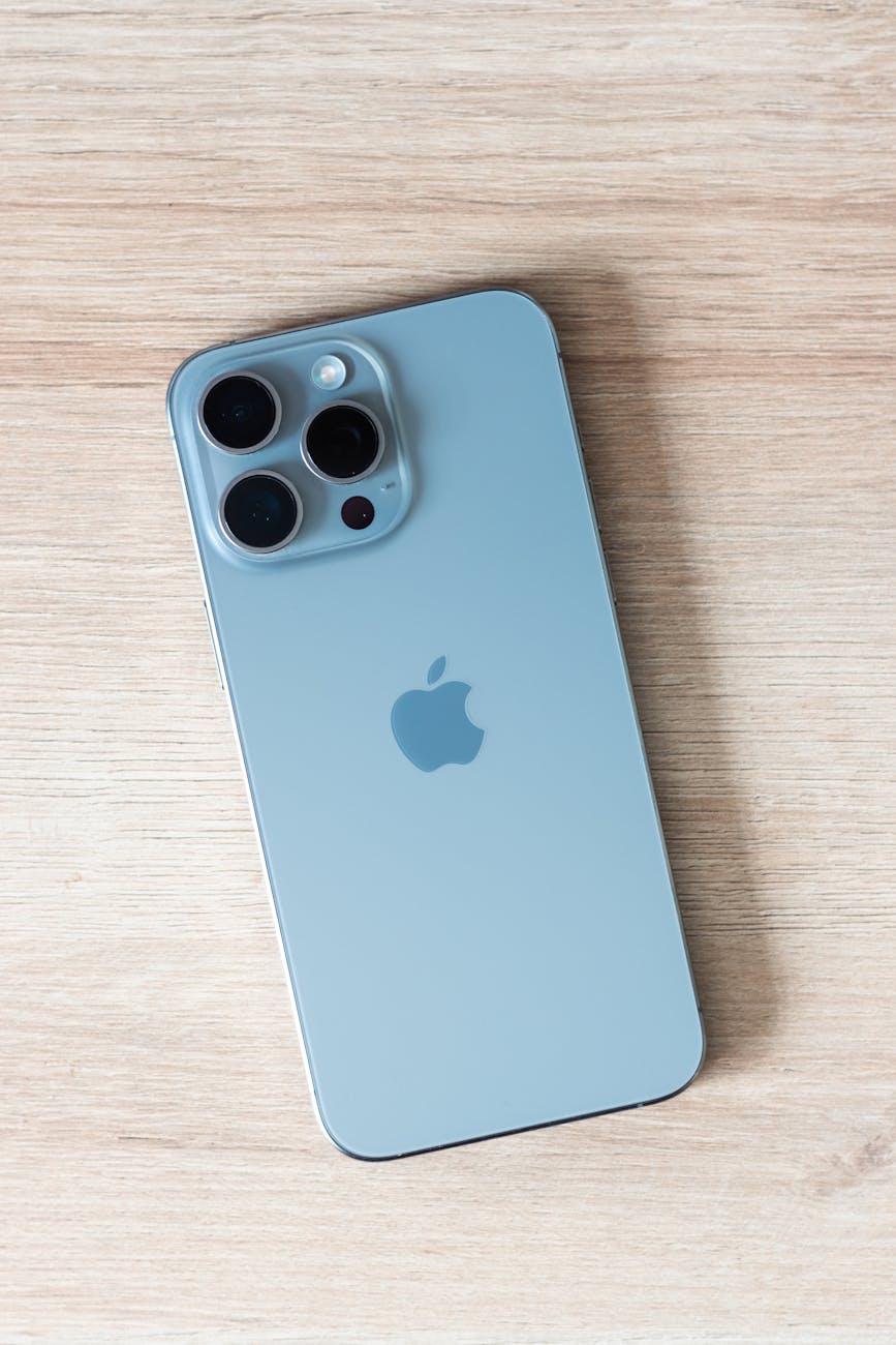 close up of a modern smartphone on a light wooden table surface
