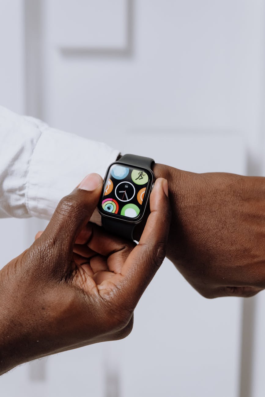 close up of two hands interacting with a smartwatch emphasizing modern technology