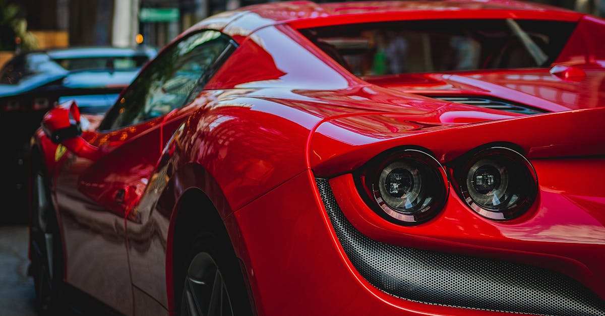 close up shot of a luxurious red sports car showcasing its sleek design and shiny surface