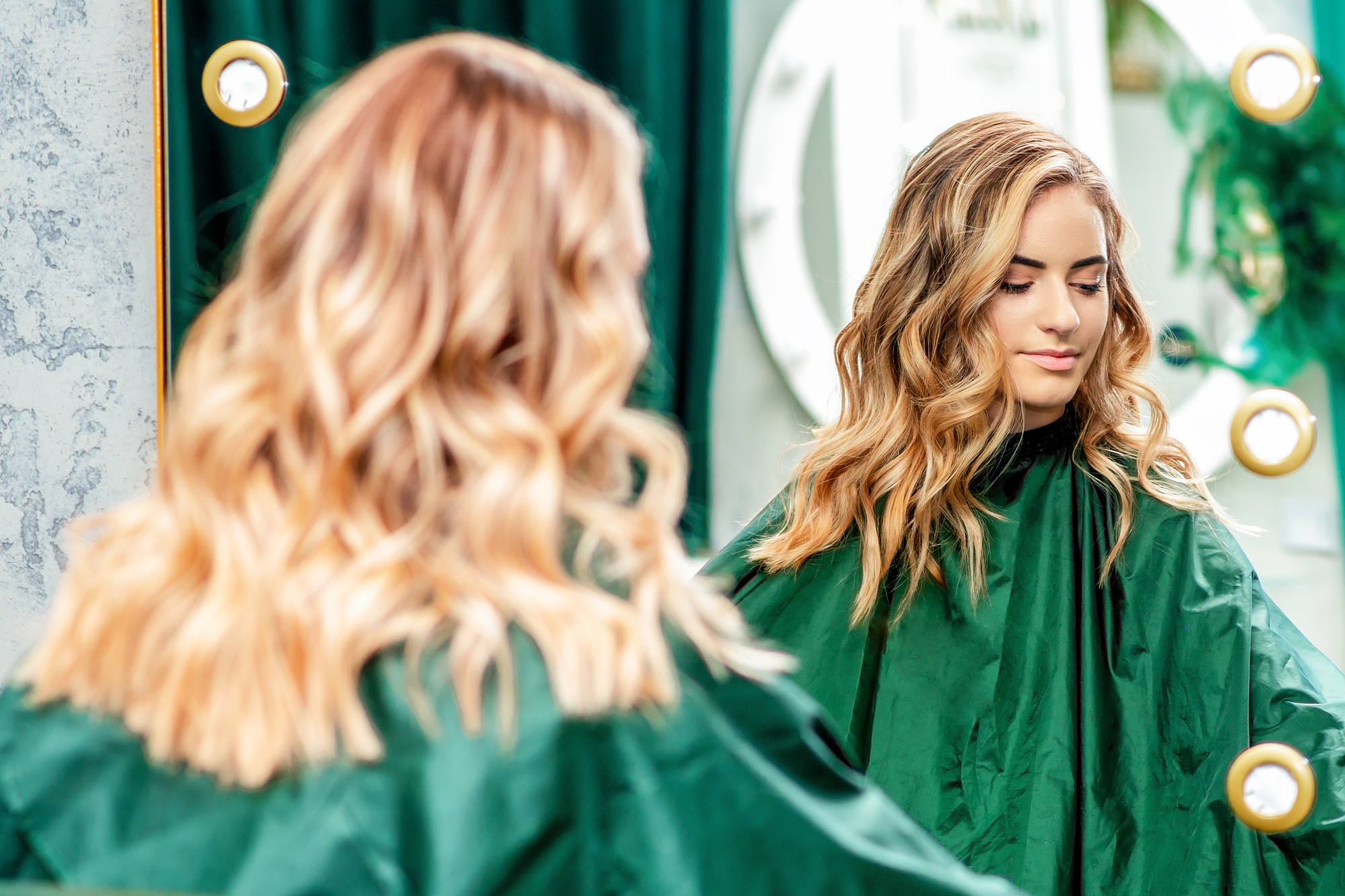 hairstyle of young woman in the mirror at beauty salon beauty concept
