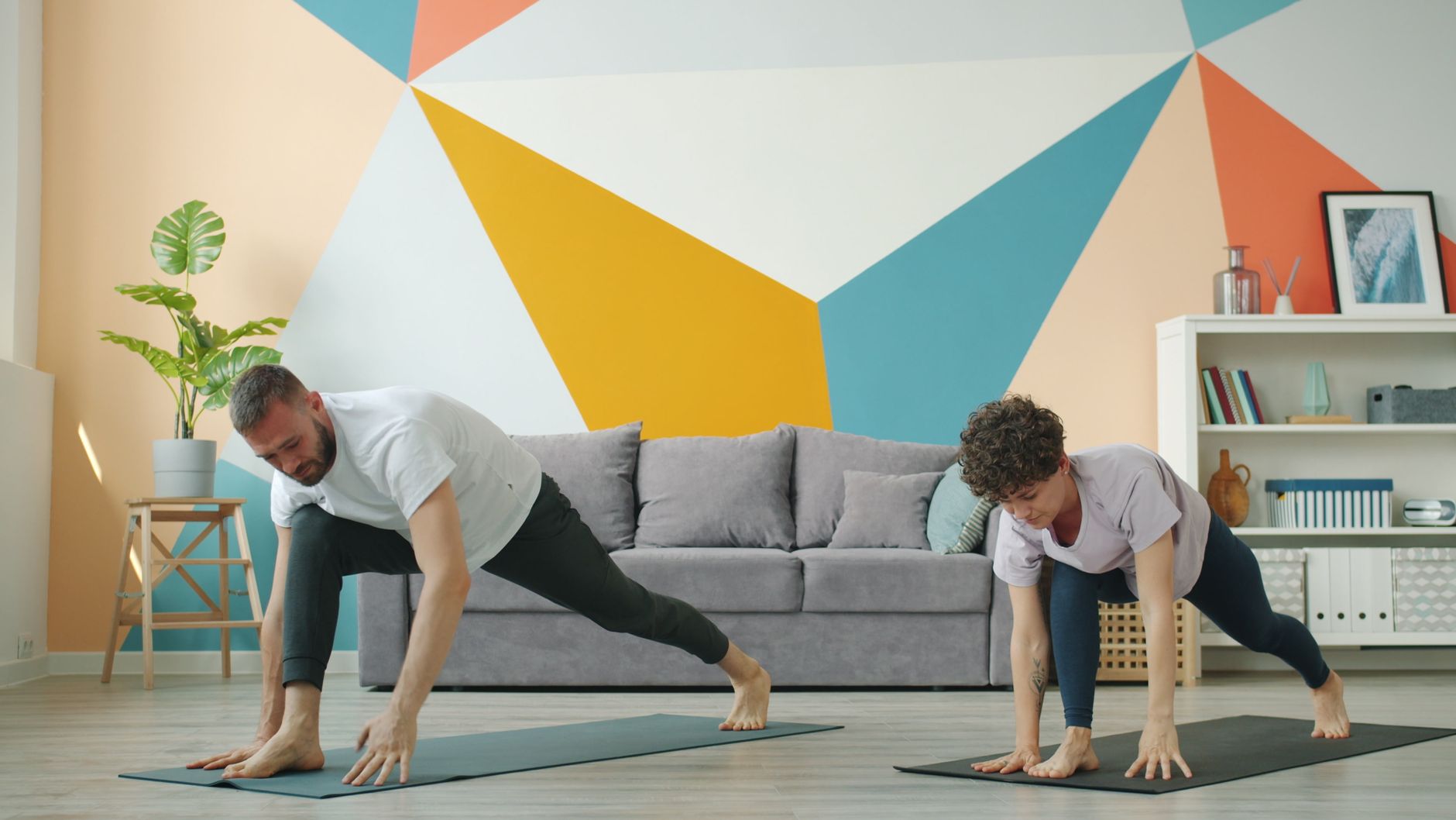couple practicing yoga poses in a colorful living room promoting wellness and relaxation