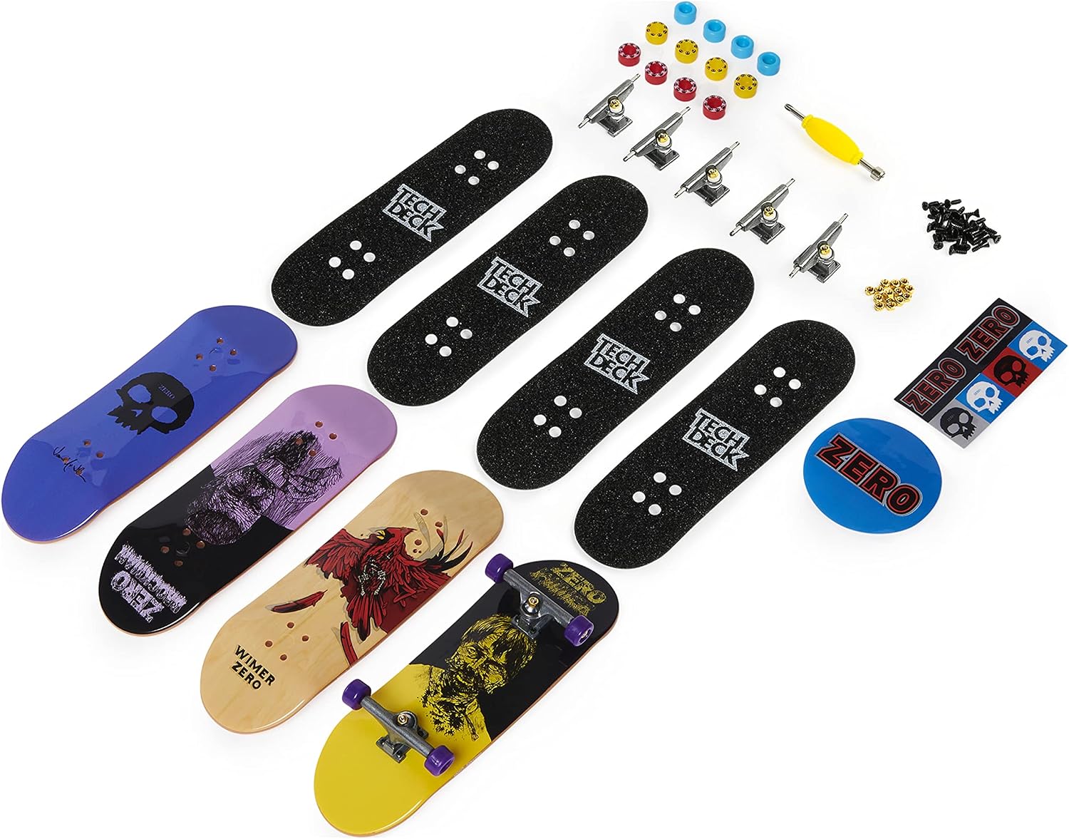 Contenu dun pack Zero étalé : planches, grips, trucks, roues, visserie, outil et autocollants