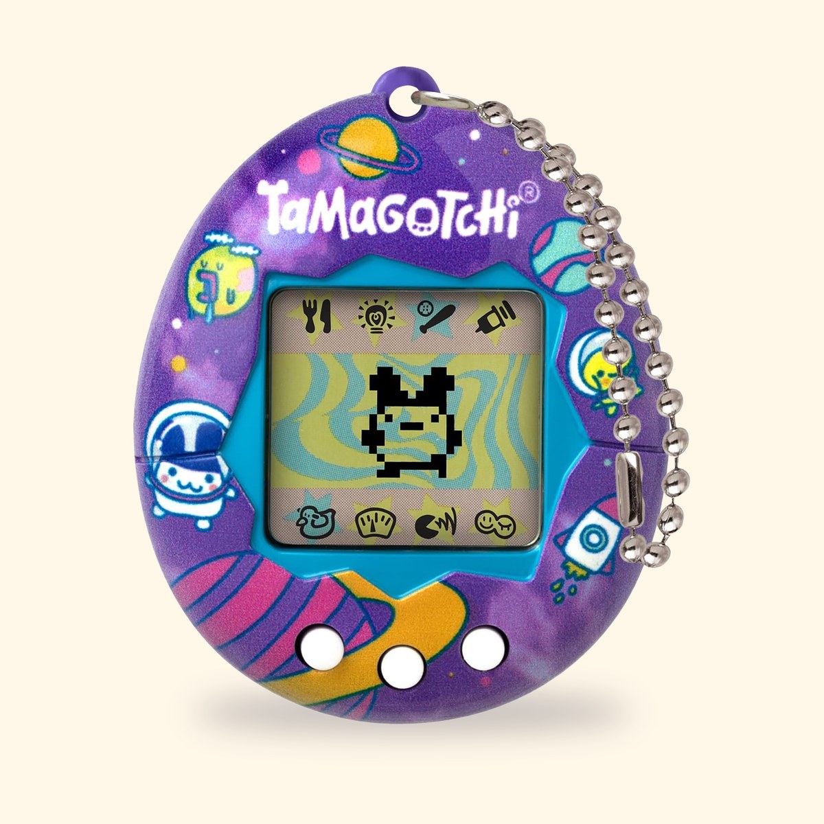 Tamagotchi Original Tama Universe à coque violette décorée de planètes et dastronautes, sur fond crème