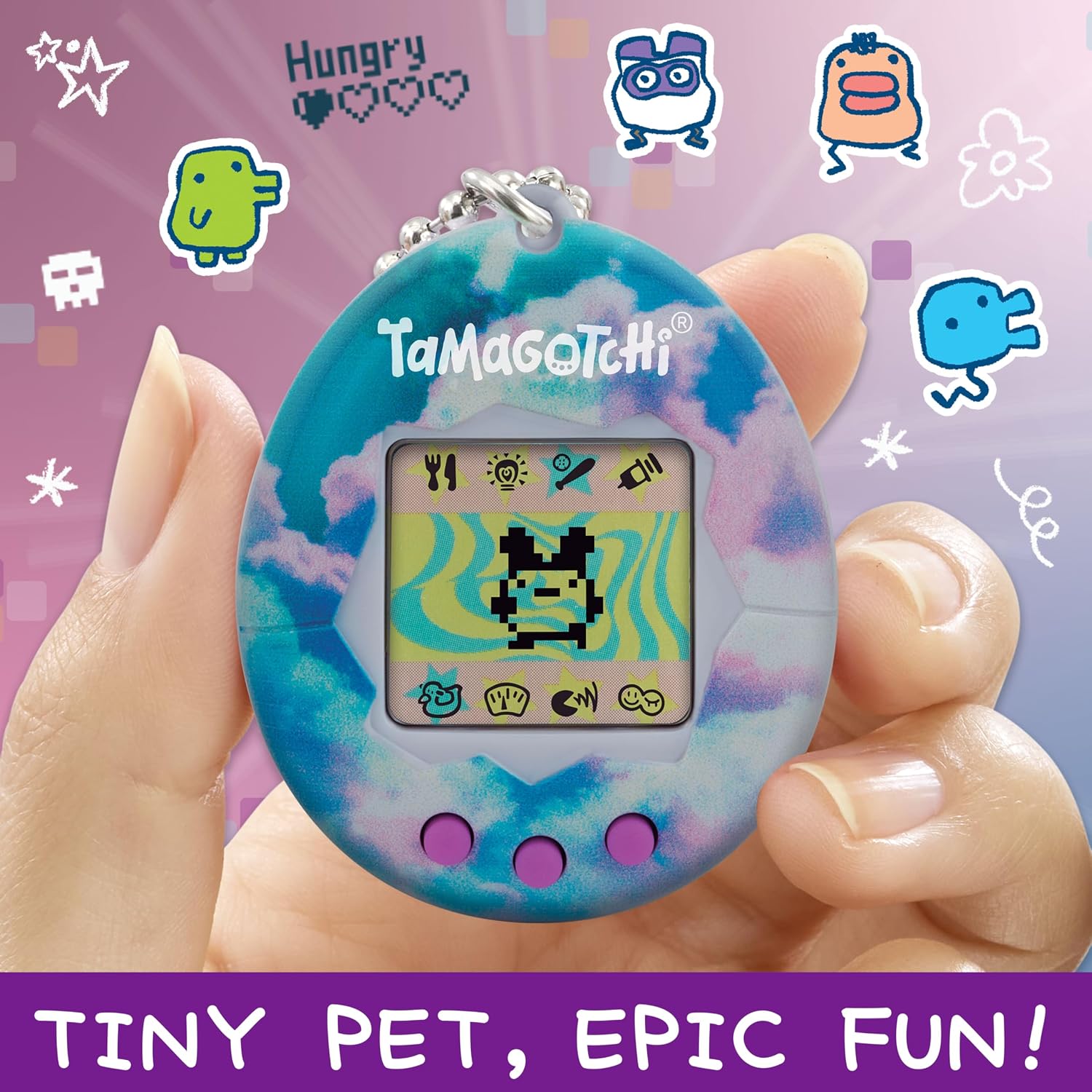 Tamagotchi Original Sky tenu entre deux doigts, visuel publicitaire en anglais