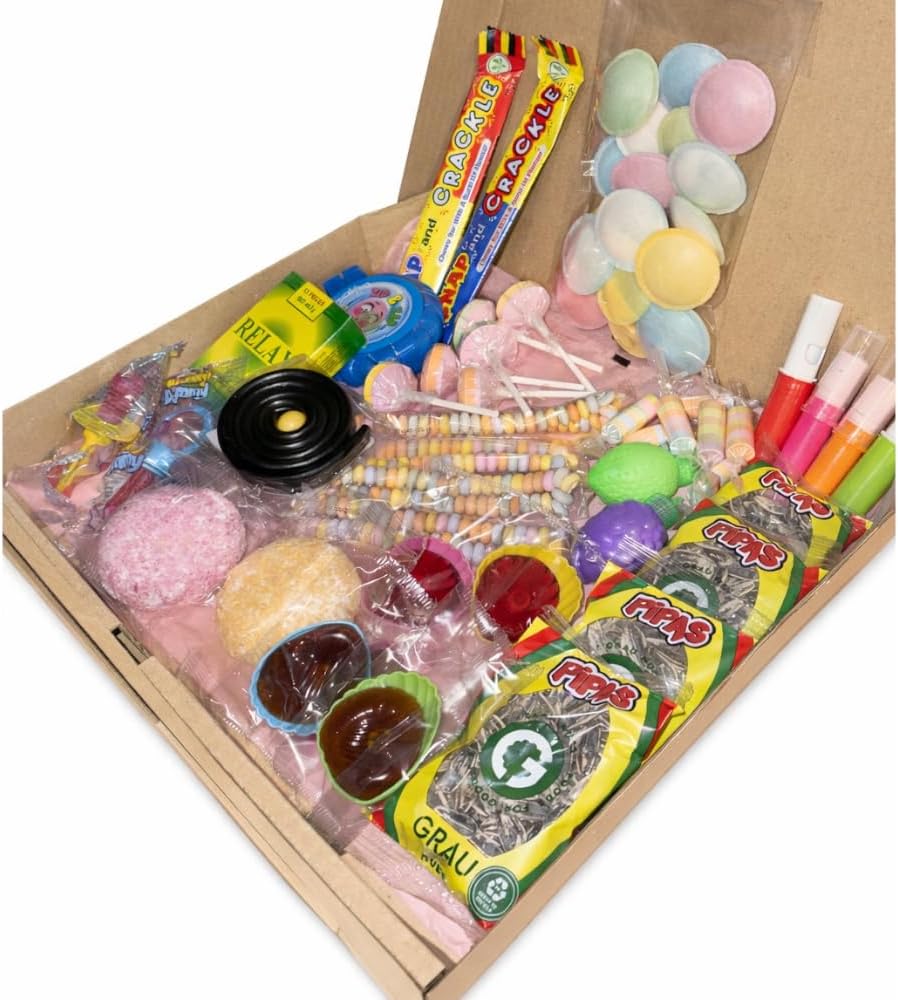 La box ouverte vue de trois quarts, bonbons posés sur du papier de soie rose