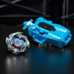 Toupie et lanceur posés sur une surface noire brillante