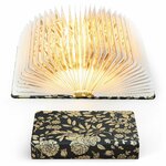 Lampe livre pliable ouverte et illuminée, et la même fermée avec sa couverture noire à fleurs dorées