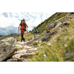 Due escursionisti con bastoncini su un sentiero di pietre in alta montagna