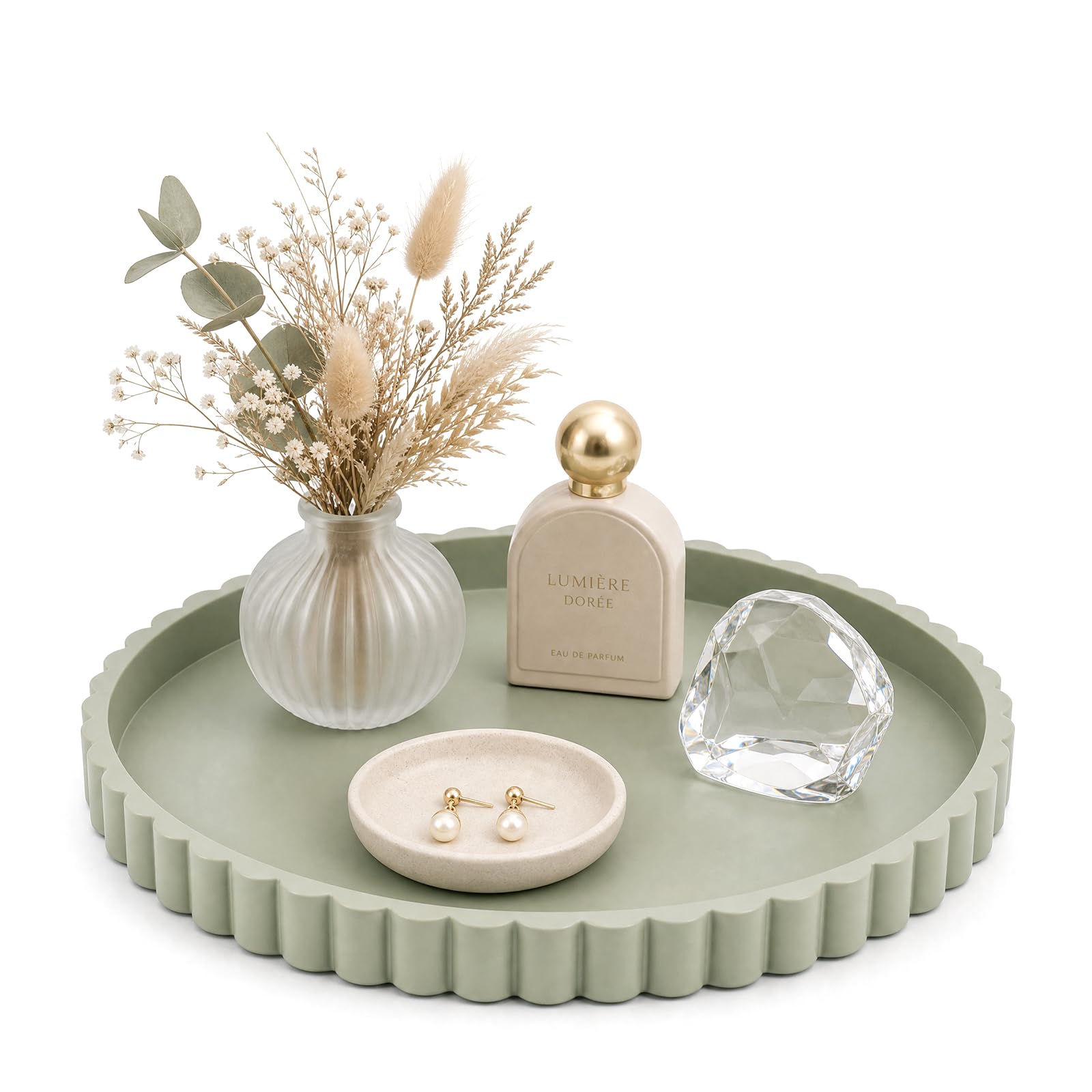 Rundes salbeigrünes Silikontablett mit Wellenrand, darauf Vase mit Trockenblumen, Parfüm und Schmuckschälchen