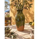 Vase Cimiez avec des branches dolivier, posé sur une table de latelier