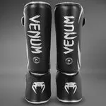 protege-tibias-venum-challenger-noir-argent-venum