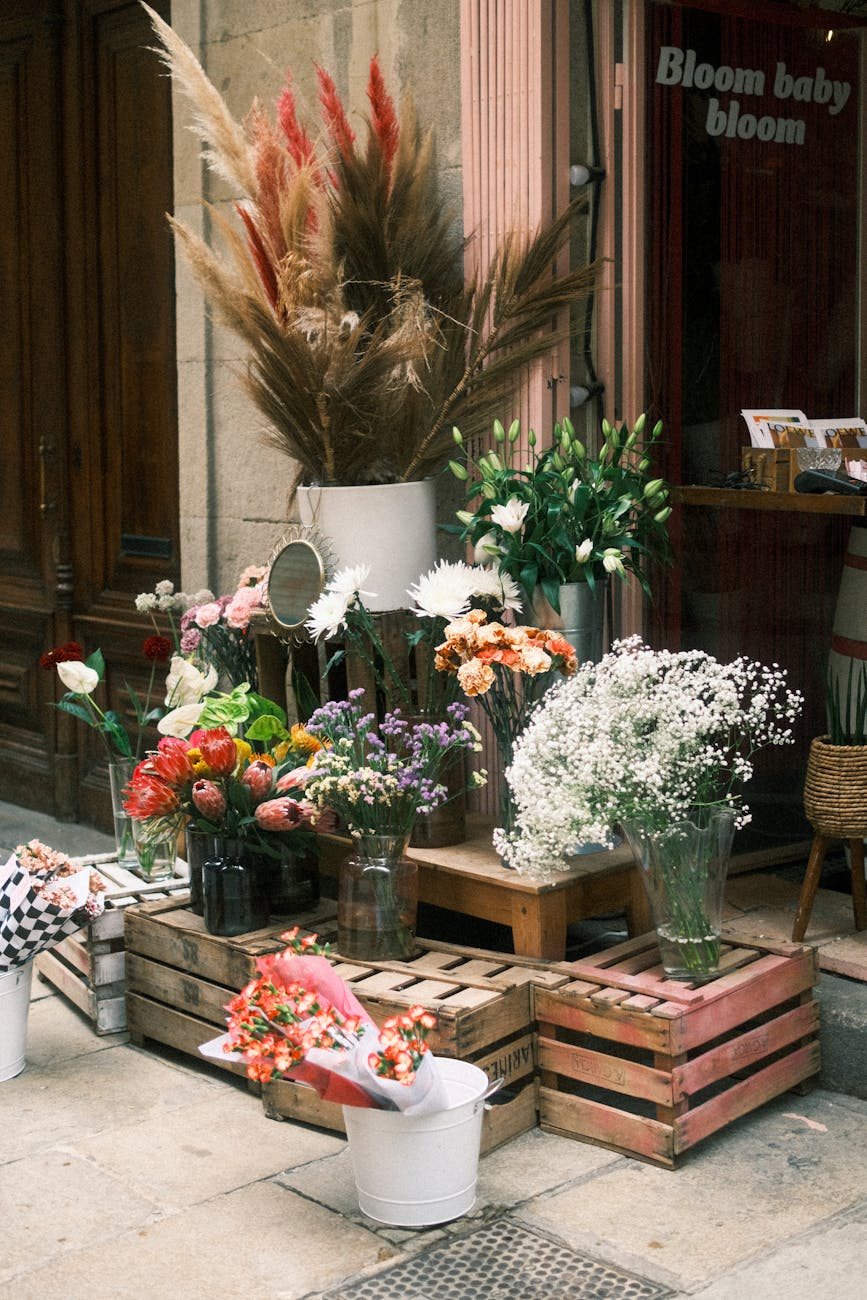 a beautiful display of colorful flowers at a sidewalk shop in barcelona spain