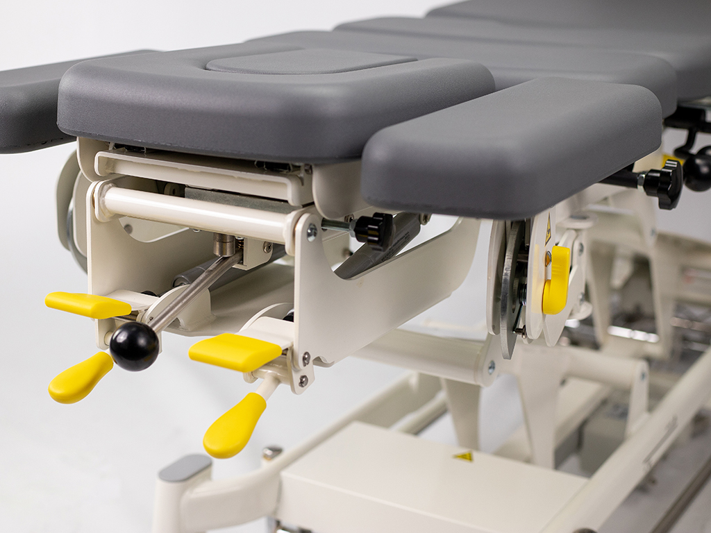 table de chiropraxie électrique habys avec drops ou toggle mécaniques vue avant têtière couleur grise
