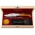 Coffret Laguiole Bougna haut de gamme avec couteau pliant manche bois clair, tire bouchon sommelier, fusil affûtage, étui noir et graisse entretien.
